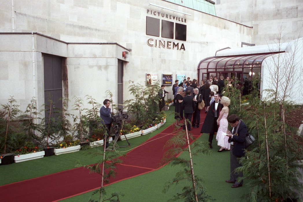 A photograph of a red carpet leading up to a white building