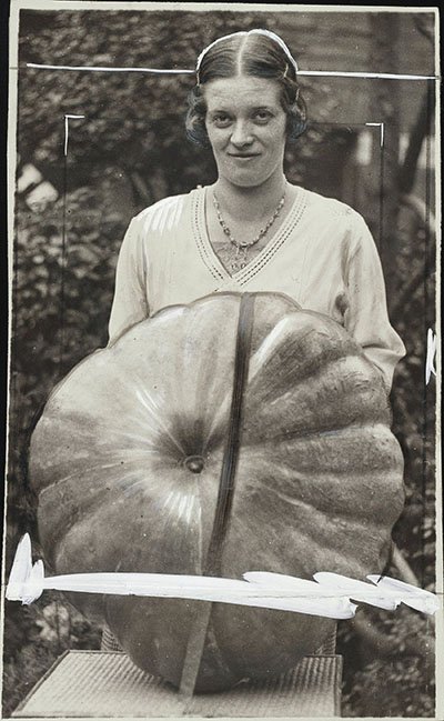 Woman posing with giant pumpkin
