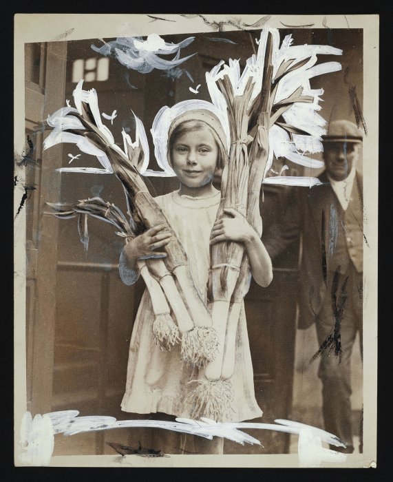 Little girl holding large leeks