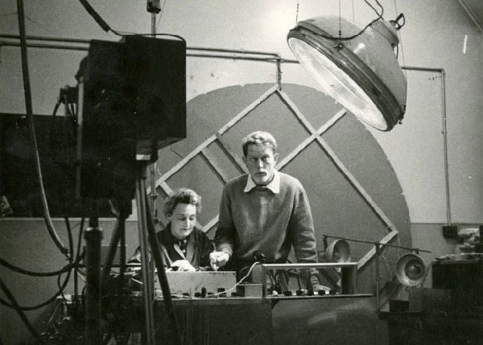 Black and white photograph of a man and a woman surrounded by scientific equipment