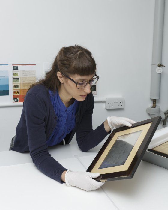 Museum conservator Vanessa Torres analysing a daguerreotype