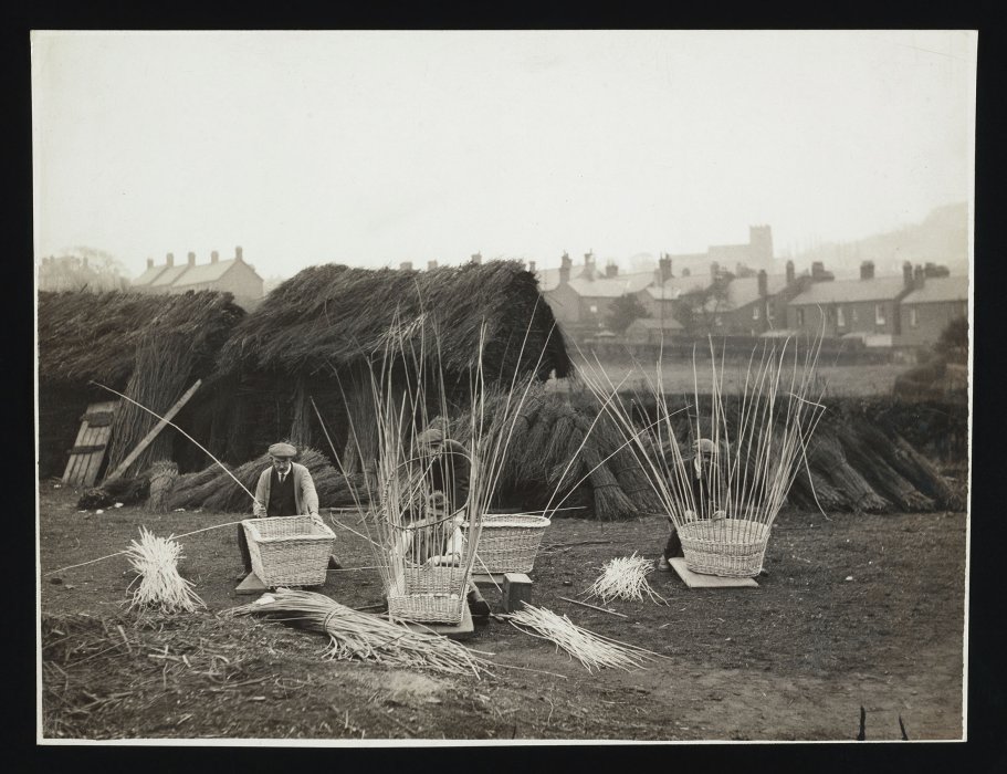 Workers making baskets from willow reeds
