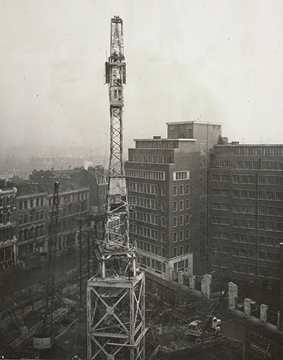 Tall crane pictured among office buildings in London