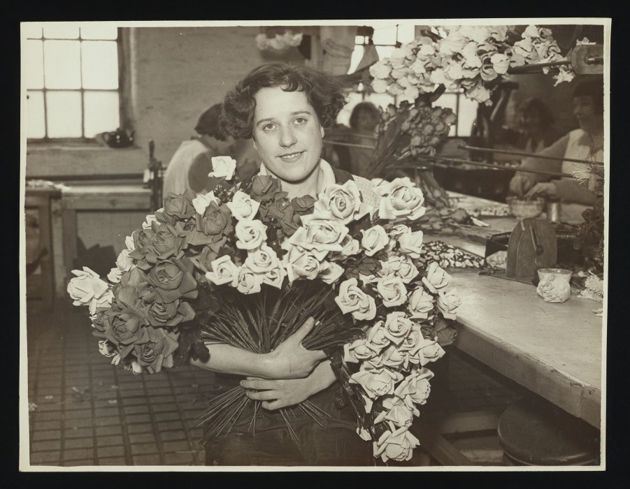 Woman holding a large bouquet of artificial roses