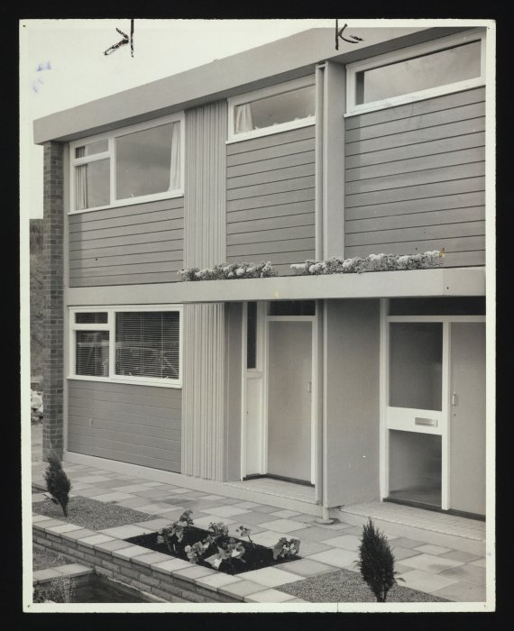 Front of modernist house with small garden area