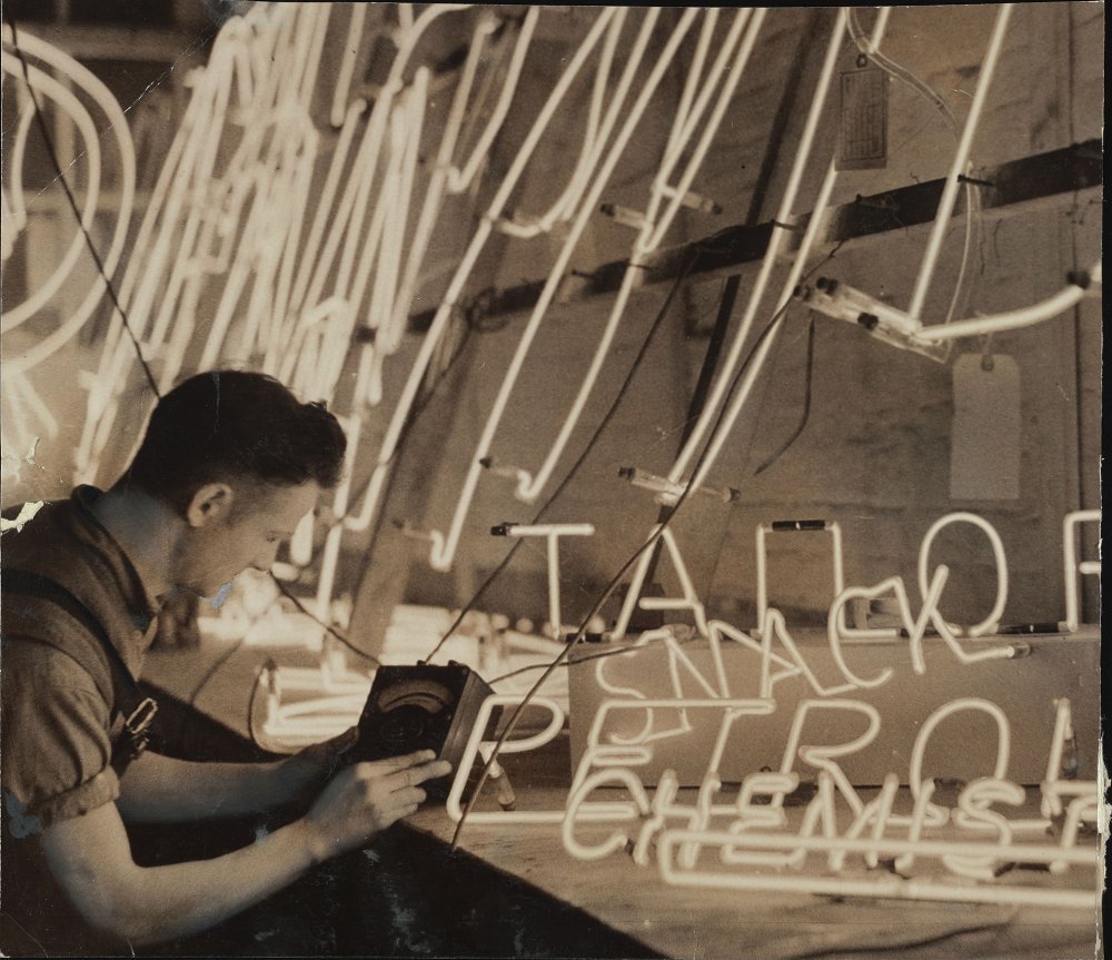 Man inspecting a neon sign