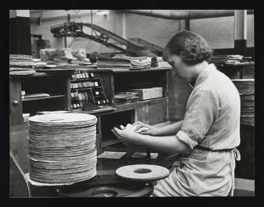 Worker wiping a record clean