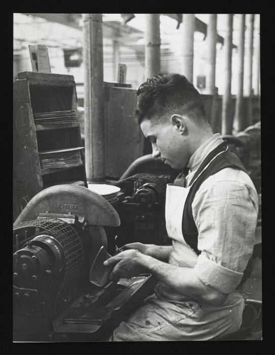 A worker polishing the edge of a record