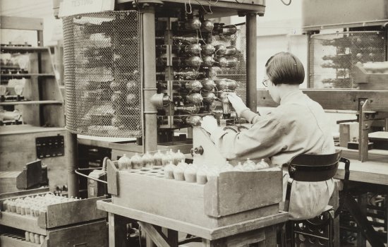 Factory worker testing parts of radios