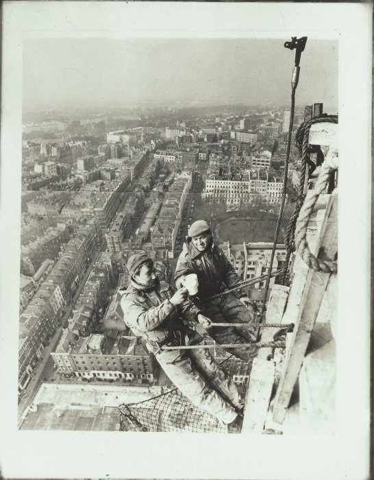 Two workers drinking tea high above the ground in London
