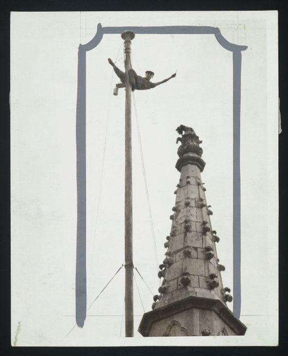 London-based steeplejack W.N. Mackney shows off to watchers below while painting the flagstaff over Westminster Abbey