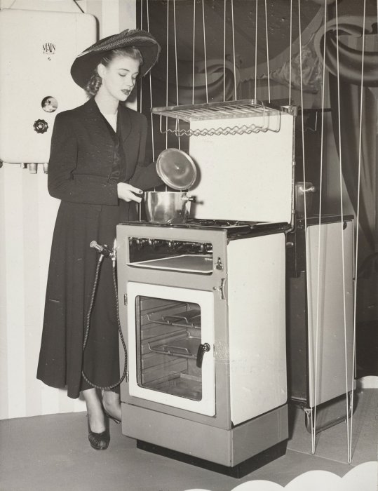 Woman demonstrating gas oven