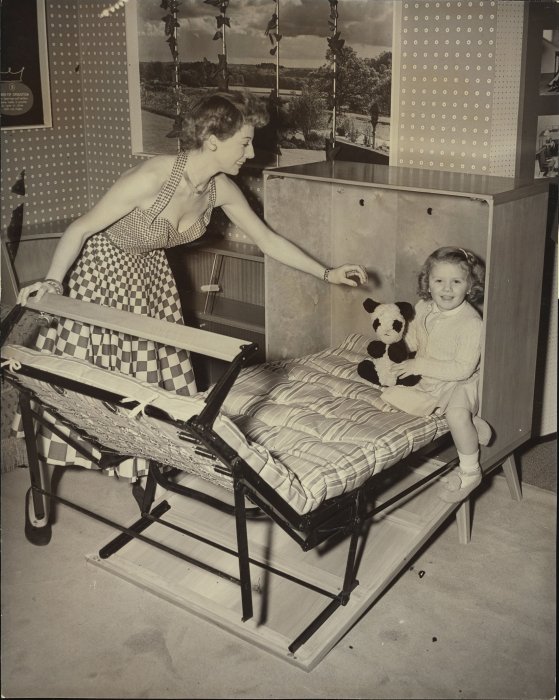 Woman and girl demonstrating fold-out bed