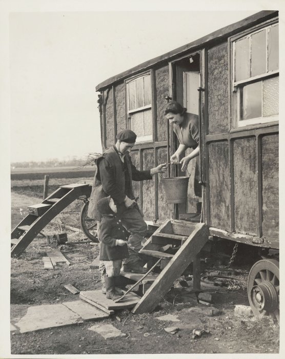 Man and woman in doorway of caravan