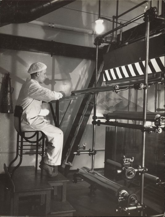 Factory worker operating film coating machine