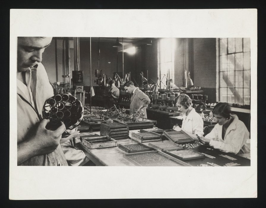 Factory workers making camera lenses