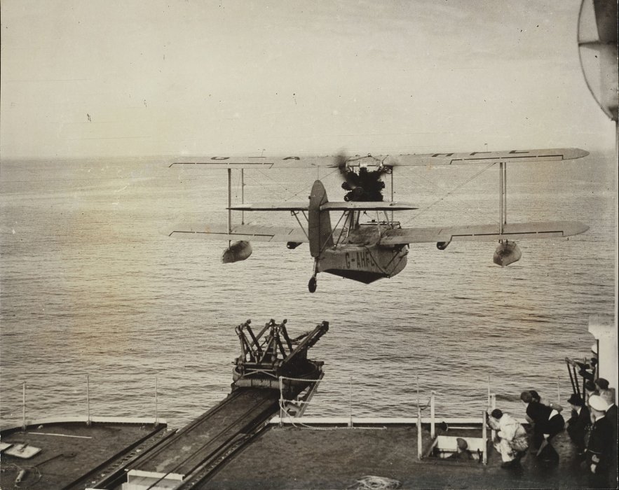 Amphibian seaplane taking off from deck of ship
