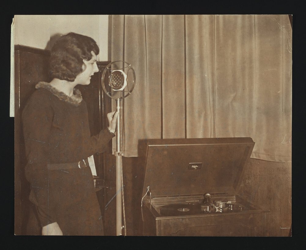 Woman recording message onto a record