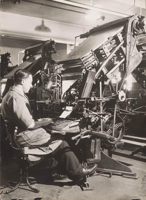 A linotype operator at work, using a typewriter-like keyboard to set stories in type for printing
